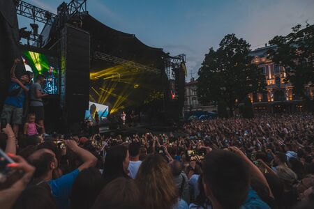 LVIV, UKRAINE - June 18, 2019: wide angel crowd before rock stage at city square. copy spaceのeditorial素材