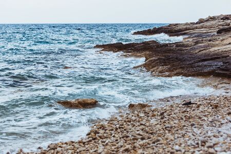 view of rocky sea beach in storm weather. copy space. backgroundの写真素材