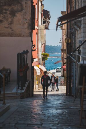 POREC, CROATIA - May 22, 2019: view of street with sea in the end between buildings. summer travel conceptのeditorial素材