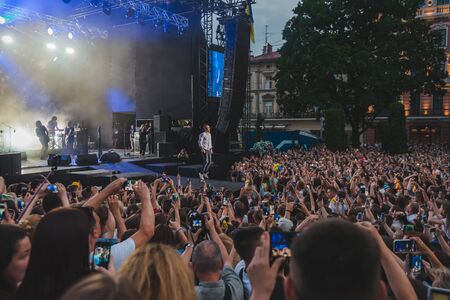 LVIV, UKRAINE - June 18, 2019: wide angel crowd before rock stage at city square. copy spaceのeditorial素材