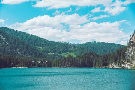 view of hotel near lake in dolomites mountains in italy. backgroundの写真素材