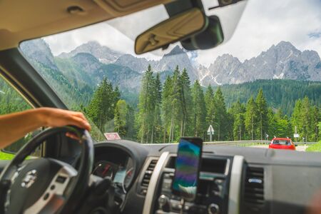 view from car inside navigation on phone mountains on background. lifestyle.