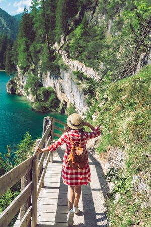 woman walking by hiking trail around braies lake in italy dolomites mountains. activity leisure lifestyleの写真素材