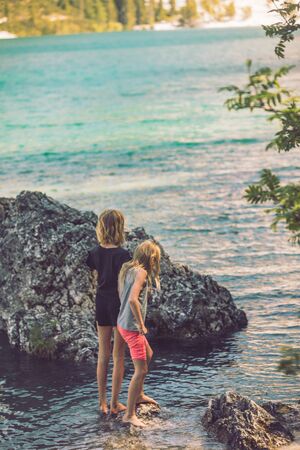kids playing at lake beach in summer time. summer time. outdoorsの写真素材