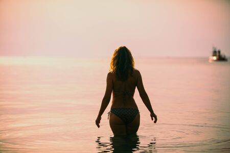 woman in swimming suit in front of sea no face summer vacation holidaysの写真素材