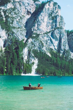 BRAIES, ITALY - June 13, 2019: people boating in mountains lake in italyのeditorial素材