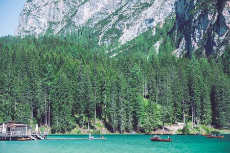 BRAIES, ITALY - June 13, 2019: people boating in mountains lake in italyのeditorial素材