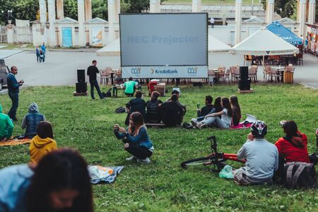 LVIV, UKRAINE - July 12, 2019: people gathered in city park to watch movie open air cinemaのeditorial素材