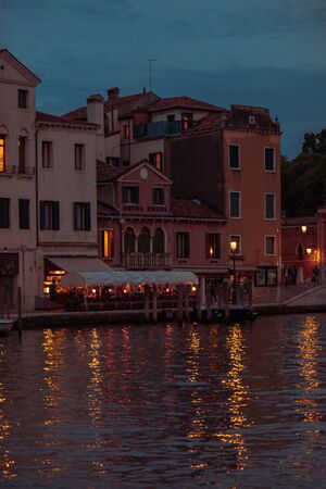 Venice, Italy - May 25, 2019: view of restaurant at city quay summer time parked boatのeditorial素材