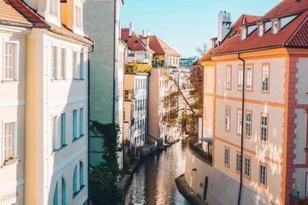view of river canal between buildings in autumn day