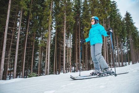 young adult woman skiing. winter sport activityの写真素材