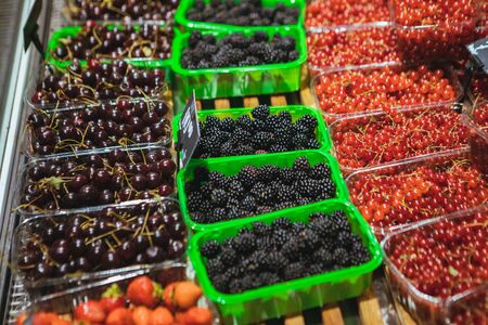 view of store shelf full of berries grocery shoppingの写真素材
