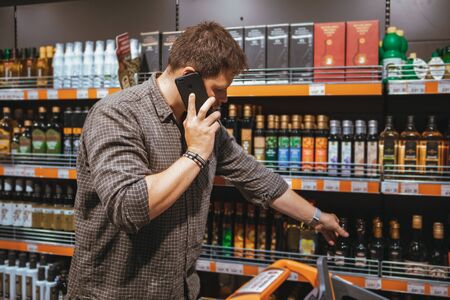 man talking on phone in grocery store need assistance in shopping list copy spaceの写真素材