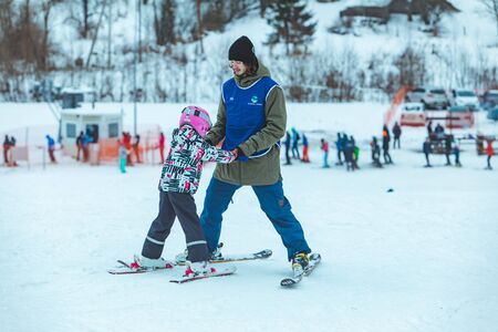 LVIV, UKRAINE - January 12, 2019: little girl novice skier. learning how to skiing. winter activitiesのeditorial素材