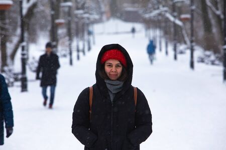 smiling woman portrait in winter outfit at city park
