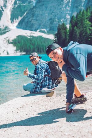 BRAIES, ITALY - June 13, 2019: friends picture at lake beach in mountains. summer timeのeditorial素材