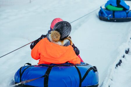 line for snow tubing. pull people up to hill. winter activitiesの写真素材