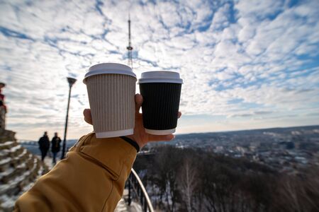 woman hand holding two coffee cup drink to go winter time wide angelの写真素材
