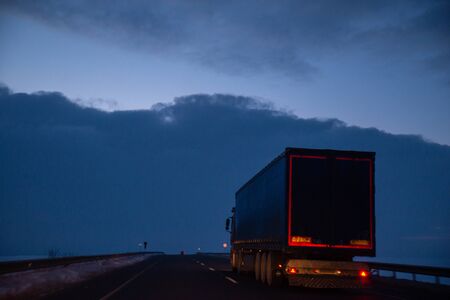 view of early morning at winter snowed highway car travel copy spaceの写真素材