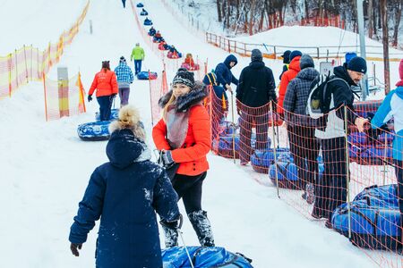 LVIV, UKRAINE - January 7, 2019: line for snow tubing. pull people up to hill. winter activities