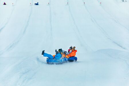 LVIV, UKRAINE - January 7, 2019: people having fun. snow tubing down by winter hill. winter time