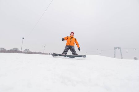 man snowboarding down by hill. winter sport timeの写真素材