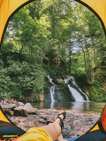 view from tent to the waterfall camping concept