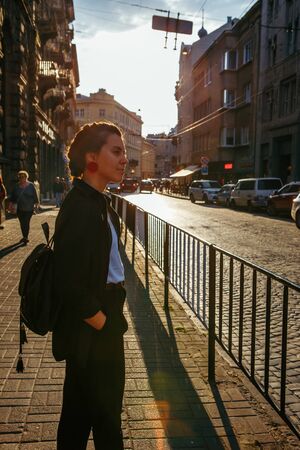 portrait of pretty woman on sunset at city streetの写真素材