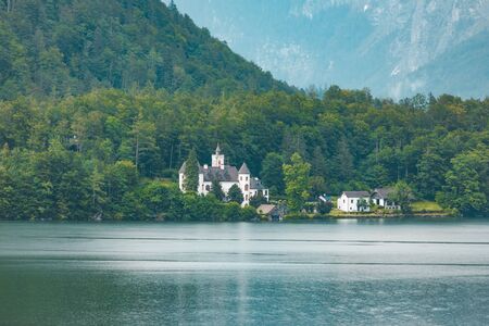 view of comfy house at lake beach in alpine mountains copy spaceの写真素材