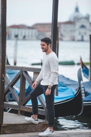 Venice, Italy - May 25, 2019: man modeling at city dock pier fashionのeditorial素材