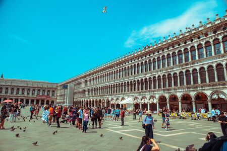 Italy, Venice - May 25, 2019: people walking by famous city square summer tripのeditorial素材