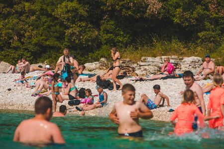 Pula, Croatia - June 12, 2019: people swimming at blue clear waterのeditorial素材