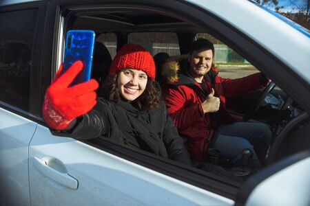 couple taking selfie picture in car road tripの写真素材