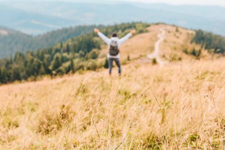 mountains travel concept autumn season yellow grass blurred person on backgroundの写真素材