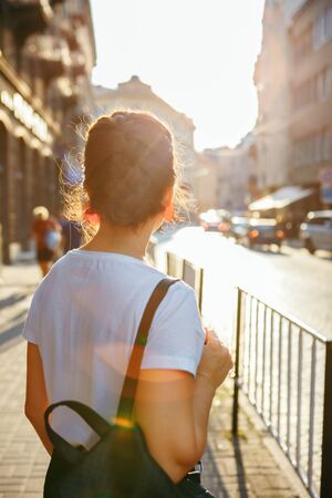 portrait of pretty woman on sunset at city street urban outfitの写真素材