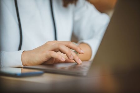 woman hand on laptop touchpad close up internet surfing
