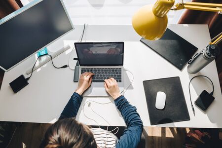 woman working on laptop at home. telework. freelance concept. overhead viewの写真素材