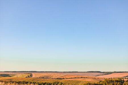 panoramic view of harvest fields on sunset blue clear skyの写真素材