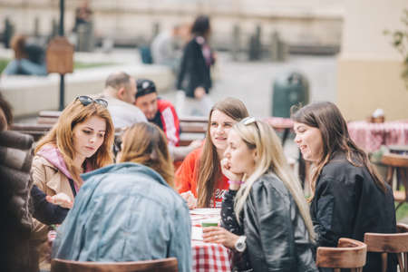 Lviv, Ukraine - May 11, 2019: view of people resting at outdoors cafe. drinking beer.のeditorial素材