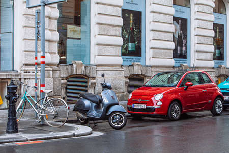 Vienna, Austria - May 16, 2019: three type of vehicle parked at street bicycle moped scooter and car...