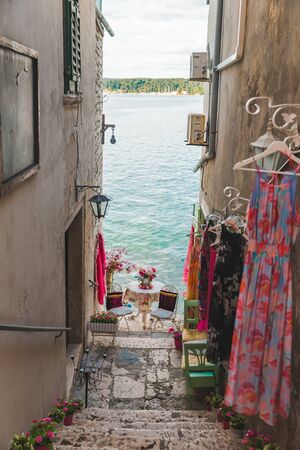 sweet cozy place table at the edge if the beach between building. romantic cafeの写真素材