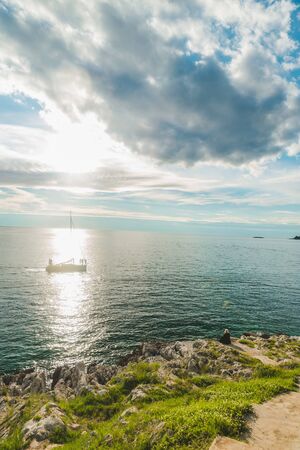 woman sitting at sea beach enjoying the beauty of sunset. copy spaceの写真素材