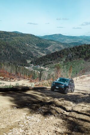 car travel concept suv driving by country road leading to the mountains