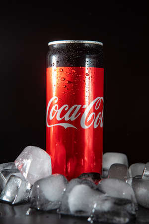 Lviv, Ukraine - May 21, 2020: coca cola metal can in ice. black background