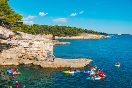 Pula, Croatia - May 31, 2019: people kayaking at clear transparent sea water. summer vacationのeditorial素材