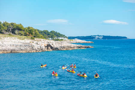 Pula, Croatia - May 31, 2019: people kayaking at clear transparent sea water. summer vacationのeditorial素材