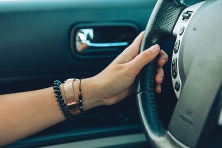 woman hands on steering wheel driving close up car travelの写真素材