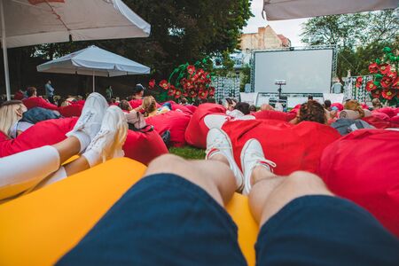 people at city public park watching movie at open air cinema. romantic dateの写真素材