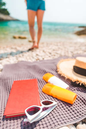 sea stuff at blanket at rocky beach copy spaceの写真素材