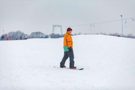 man snowboarding down by hill. winter sport timeの写真素材